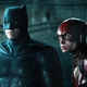 Ben Affleck in his Batman outfit and Ezra Miller in his Flash armor stare at something mysterious.